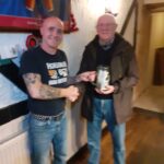 Ron being presented with a beer mug of donations from Ruby Harries.